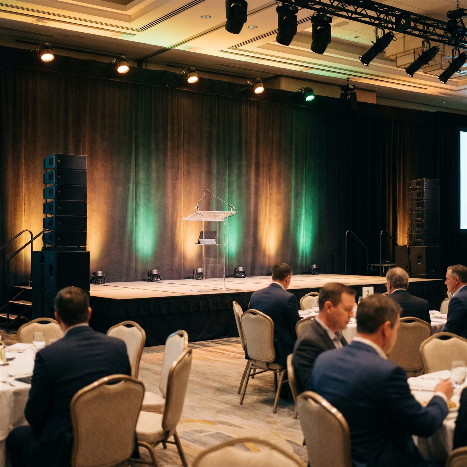 Stage, uplighting and AV set for a corporate event in Edmonton